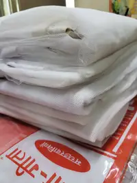 White bed mosquito net stack — institutional machardani