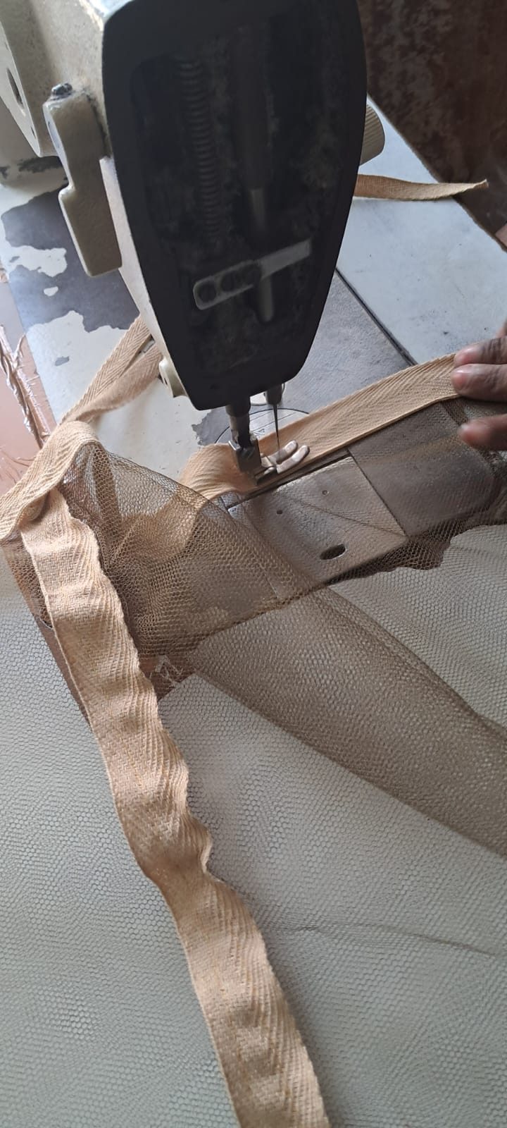 Double-stitched cotton tape border on khaki bed mosquito net — quality assurance